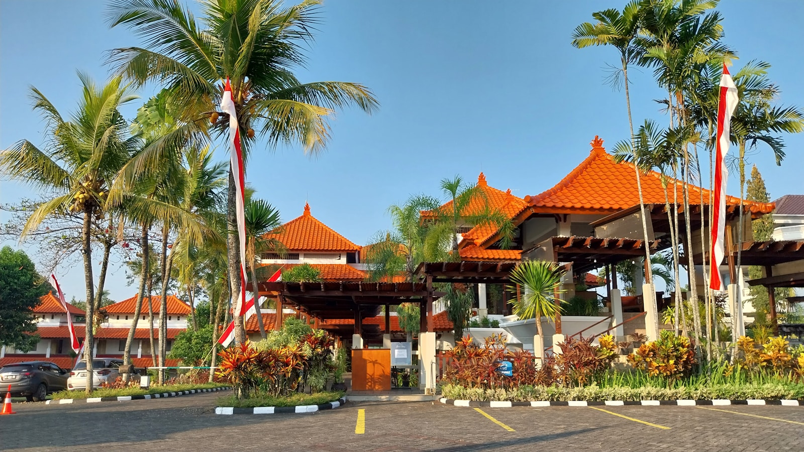 a building with a lot of palm trees in front of it